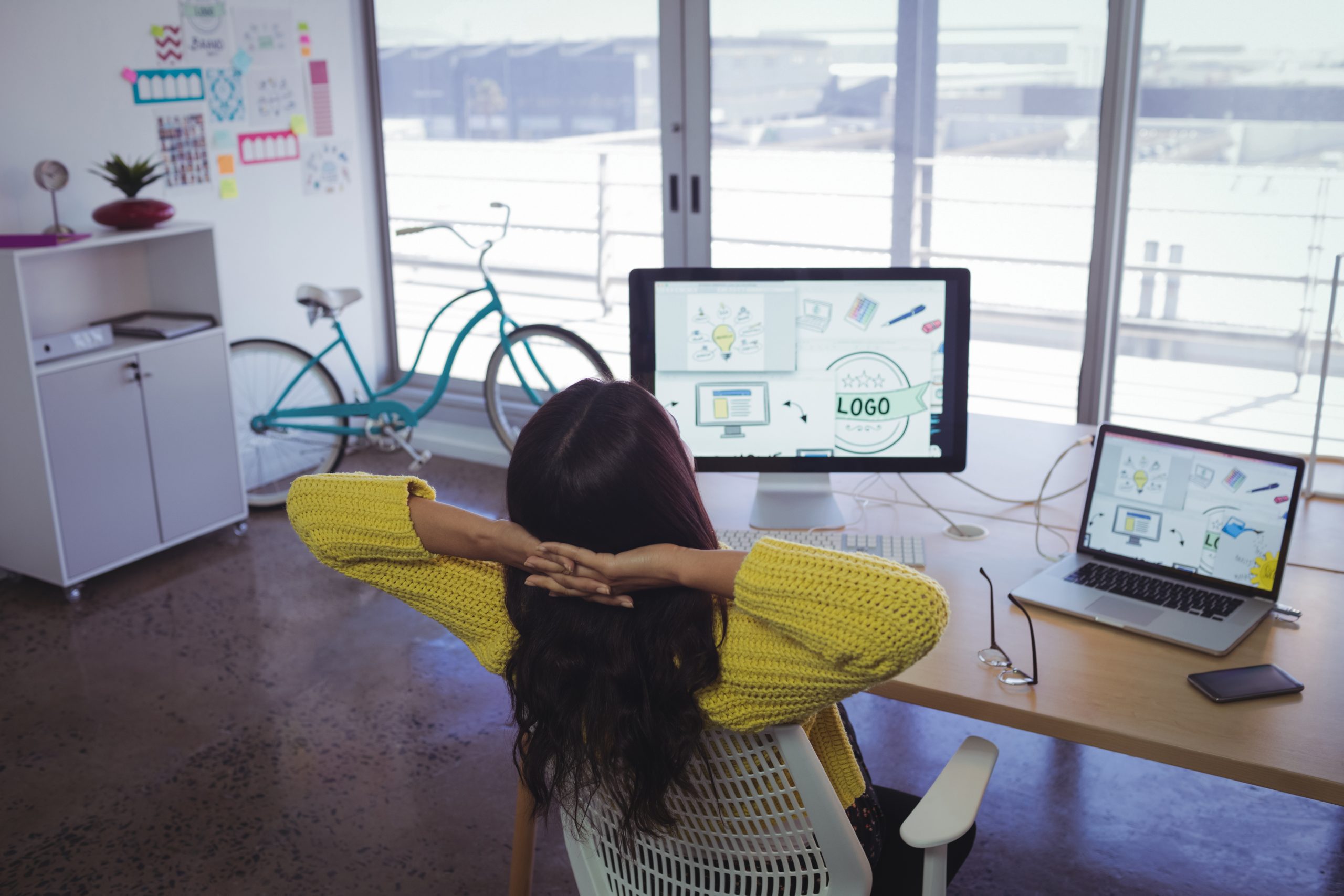 Rear view of businesswoman resting in office
